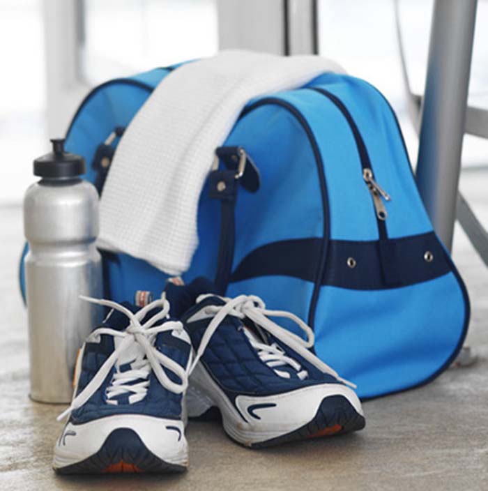 Elevated view of sports bag and water bottle and running shoes and a towel